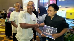 Kepala Disporapar Baihaqi mendampingi Sekretaris Daerah Kota Malang Erik Setyo Santoso menyerahkan hadiah pemenang lomba infografis dan video grafis, Kamis (3/10). Foto: Tugusatu/Bagus Suryo