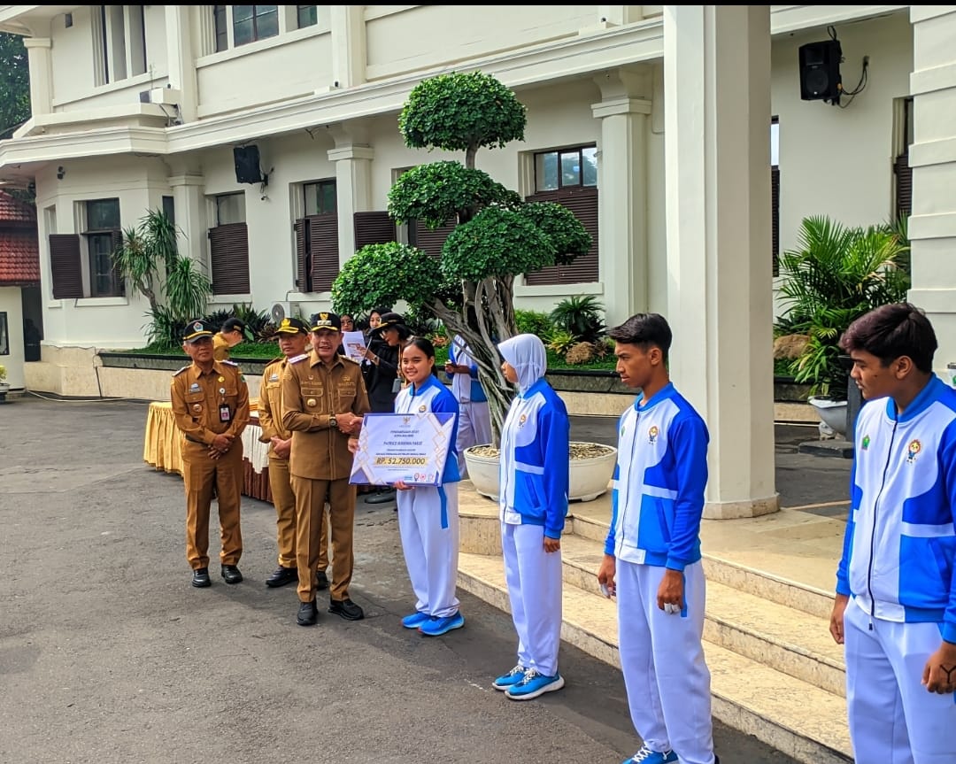 Wali Kota Malang Wahyu Hidayat memberikan bonus kepada atlet dan pelatih Porprov 2025. Foto: Tugusatu/Maghfirotul Hasanah
