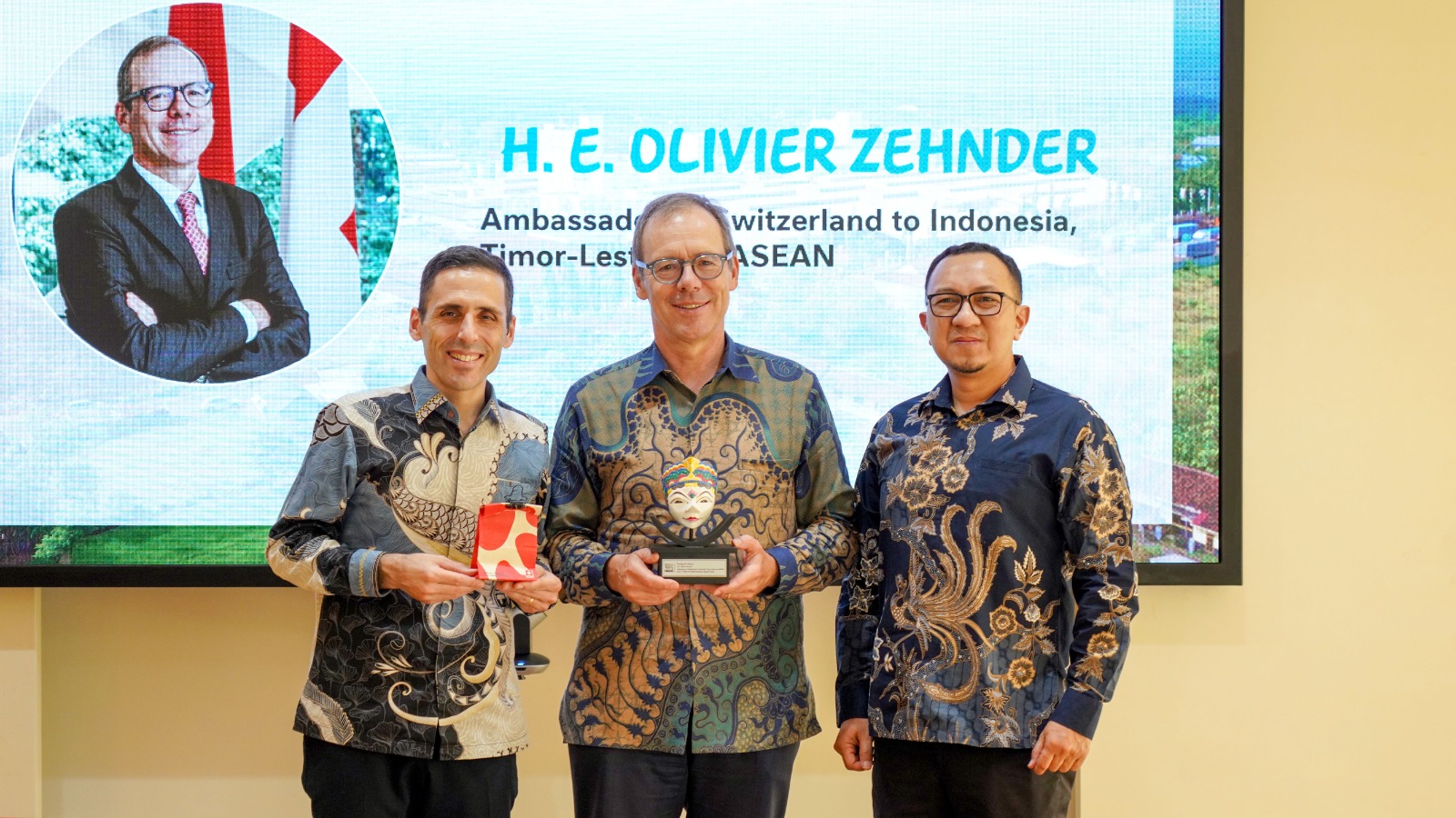 Technical Director Nestlé Indonesia, Antonio Prochilo (kiri), menyerahkan cenderamata kepada Duta Besar Swiss untuk Indonesia, Timor-Leste, dan ASEAN, H.E. Olivier Zehnder (tengah), disaksikan oleh Direktur Human Resources Nestlé Indonesia, Fahrul Irvanto (kanan), sebagai simbol apresiasi atas kunjungan serta kemitraan yang terus dibangun dalam mendukung pengembangan sektor susu berkelanjutan di Indonesia. Istimewa
